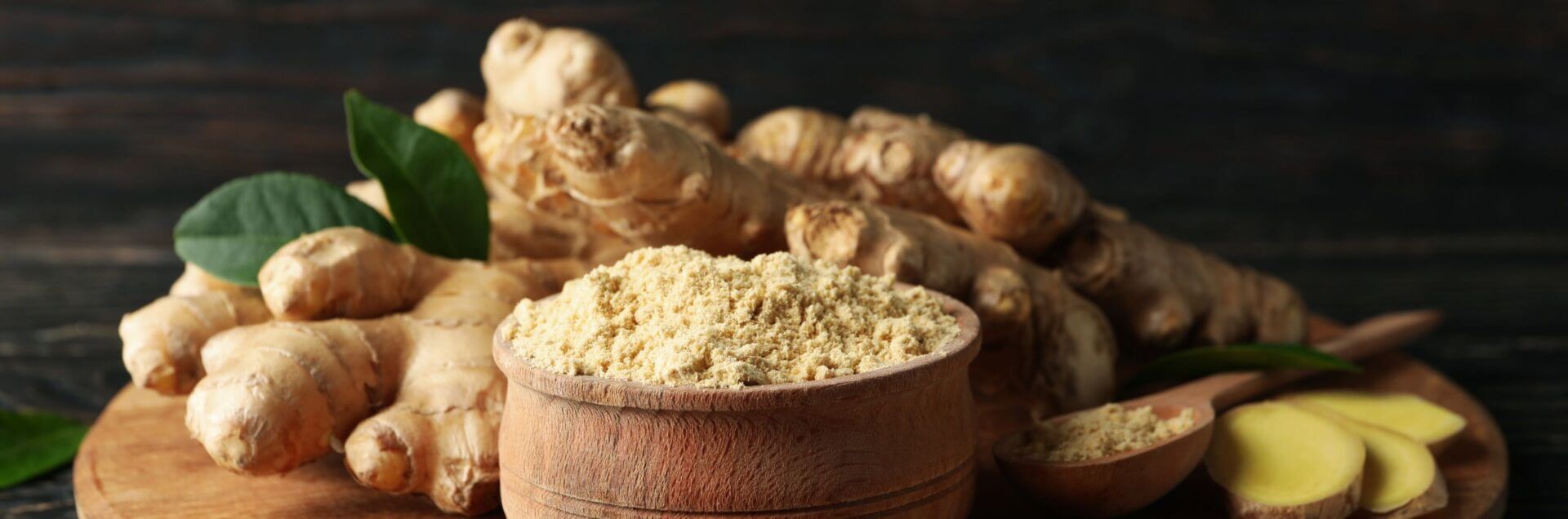 Ginger Benefits Through Herbal Formulas -ground ginger in bowl and fresh ginger