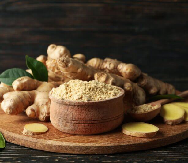 Ginger Benefits Through Herbal Formulas -ground ginger in bowl and fresh ginger