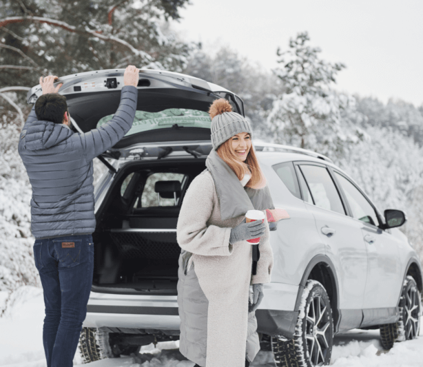 TCM for motion sickness - woman and man getting out of car in snowy area