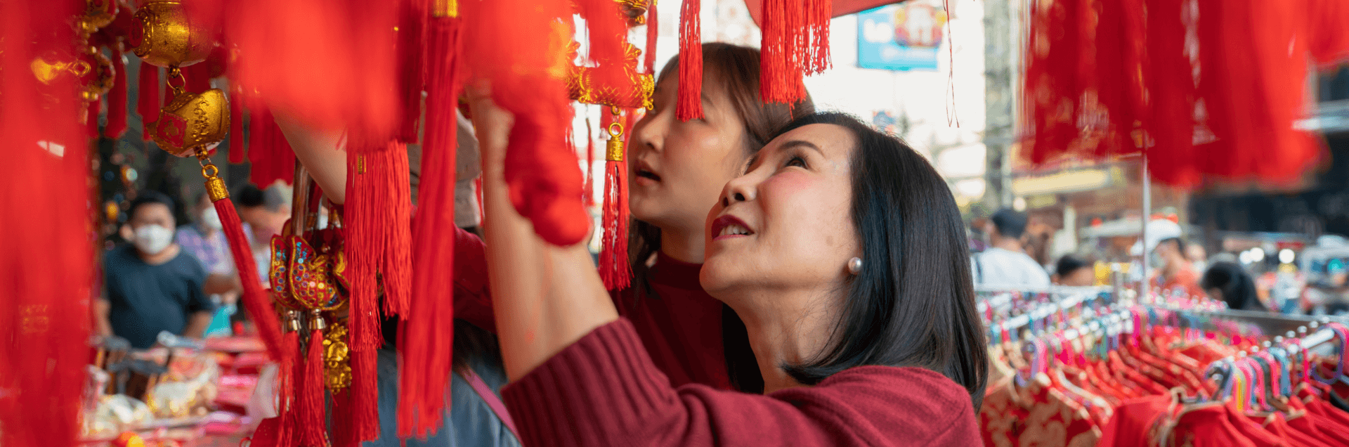 Celebrating Chinese Lunar New Year and Incorporating TCM - woman looking at red lanterns and Chinese new year decorations